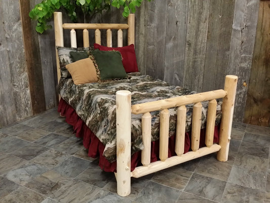 Rustic log bedroom furniture featuring a handcrafted wooden bed with a nature-inspired bedding set in a cozy cabin-style room.